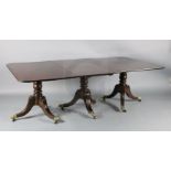 A Regency mahogany triple pillar extending dining table, with D shaped ends and two leaves, on