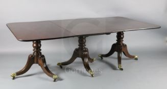A Regency mahogany triple pillar extending dining table, with D shaped ends and two leaves, on