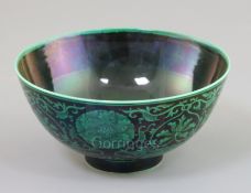 A Chinese green and black enamelled bowl, Qianlong mark, painted with lotus flowers and scrolling