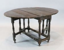 An early 18th century oak oval topped gateleg dining table, with turned and squared underframe,