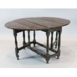 An early 18th century oak oval topped gateleg dining table, with turned and squared underframe,