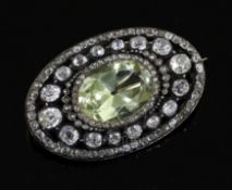 A Victorian gold and silver, pale green beryl and diamond set oval brooch, set with old and mine cut