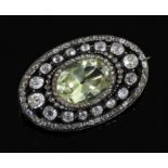 A Victorian gold and silver, pale green beryl and diamond set oval brooch, set with old and mine cut