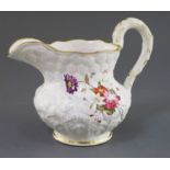 A Rockingham porcelain water jug, c.1830, moulded with flowers and leaves, each side painted with