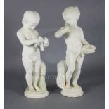 A pair of 19th century Italian carved white marble figures of putti, one holding a bird's nest,