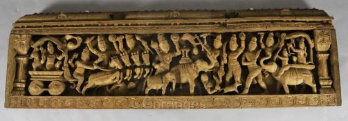 An Indian teak pediment, 19th century carved in high relief with a procession of Hindu deities