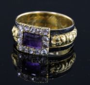 A George IV gold, black enamel, foil backed amethyst and rose cut diamond set mourning ring, with