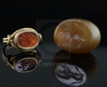 An antique gold and intaglio ring and an intaglio pendant, the ring with beaded border and scrolling
