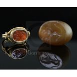 An antique gold and intaglio ring and an intaglio pendant, the ring with beaded border and scrolling