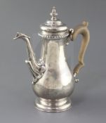 A modern George II style coffee pot by Rodney C. Pettit, of baluster form, with leaf capped spout