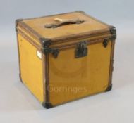 A 1920's Louis Vuitton small travelling trunk, with tan orange leather bound by brass studded