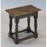 A James I oak joint stool, with lunette carved frieze, carved and fluted legs and all-round