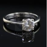 A modern 18ct white gold and solitaire diamond ring, the round brilliant cut stone measuring