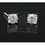 A pair of 18ct white gold and solitaire diamond ear studs, each stone with a diameter of