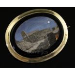 A Victorian gold mounted oval micro mosaic pendant brooch, depicting the Colosseum by moonlight,
