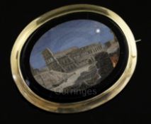 A Victorian gold mounted oval micro mosaic pendant brooch, depicting the Colosseum by moonlight,