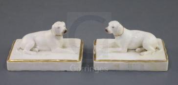 A pair of Rockingham porcelain figures of pointers, c.1830, each recumbent on a fluted rectangular