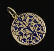 A Victorian gold and blue enamel mourning pendant locket, with scrolling arabesque decoration and