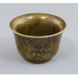 A Chinese bronze wine cup, possibly 18th century, cast in relief with foliage and characters to