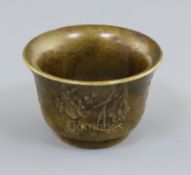 A Chinese bronze wine cup, possibly 18th century, cast in relief with foliage and characters to