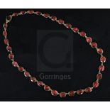A Victorian gold and foiled back oval cut garnet necklace, with four loose garnet set links, approx.