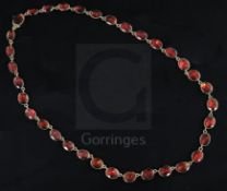 A Victorian gold and foiled back oval cut garnet necklace, with four loose garnet set links, approx.