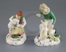 A pair of Rockingham porcelain groups of a boy feeding a rabbit and a girl seated with a lamb, c.