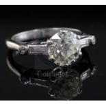 A mid 20th century 18ct white gold and single stone diamond ring with baguette and round cut diamond