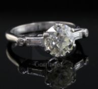 A mid 20th century 18ct white gold and single stone diamond ring with baguette and round cut diamond