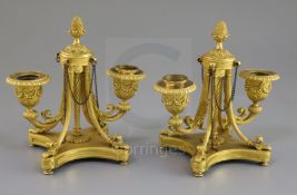 A pair of George III Empire style ormolu two-light candelabra, with central pineapple knops and