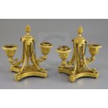 A pair of George III Empire style ormolu two-light candelabra, with central pineapple knops and