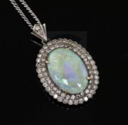 An antique gold, white opal and diamond cluster oval pendant, on a later 9ct white gold chain,