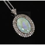 An antique gold, white opal and diamond cluster oval pendant, on a later 9ct white gold chain,