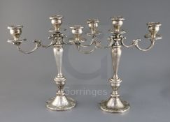 A pair of American Gorham sterling silver, two branch, three light candelabra, decorated with scroll