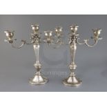 A pair of American Gorham sterling silver, two branch, three light candelabra, decorated with scroll