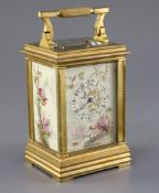 An early 20th century ormolu and porcelain hour repeating carriage clock, the dial and side panels