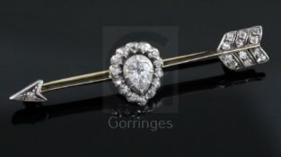 A late Victorian gold and diamond set arrow shaped bar brooch, with central pear shaped diamond,