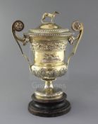 A handsome George III silver gilt two handled presentation pedestal trophy cup and cover by