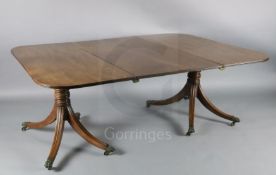 A Regency mahogany twin pillar extending dining table, with moulded D shaped ends and one leaf, on