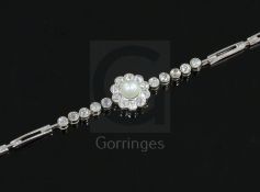 A mid 20th century 14ct gold, diamond and cultured pearl cluster set bracelet, 18cm.