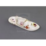 A Rockingham porcelain model of a slipper, c.1830-42, painted with flower sprays, the interior of