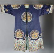 A Chinese noblewoman's embroidered silk midnight blue surcoat (longgua), late 19th century, finely
