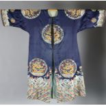 A Chinese noblewoman's embroidered silk midnight blue surcoat (longgua), late 19th century, finely