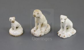 Three Rockingham porcelain toy figures of seated dogs, c.1830, two modelled as foxhounds, the