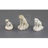 Three Rockingham porcelain toy figures of seated dogs, c.1830, two modelled as foxhounds, the