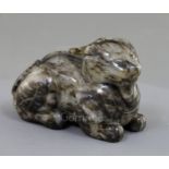 A Chinese pale grey and black jade recumbent figure of a lion-dog, length 8.3cm