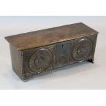 A small late 16th century carved oak six plank coffer, with triple roundel carved front, W. 2ft 6.