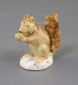 A Rockingham porcelain figure of a red squirrel, c.1830, painted in naturalistic colours, on an oval