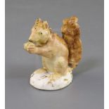 A Rockingham porcelain figure of a red squirrel, c.1830, painted in naturalistic colours, on an oval
