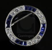 A modern Boodle & Dunthorne 18ct white gold, sapphire and diamond openwork circular brooch, 24mm.